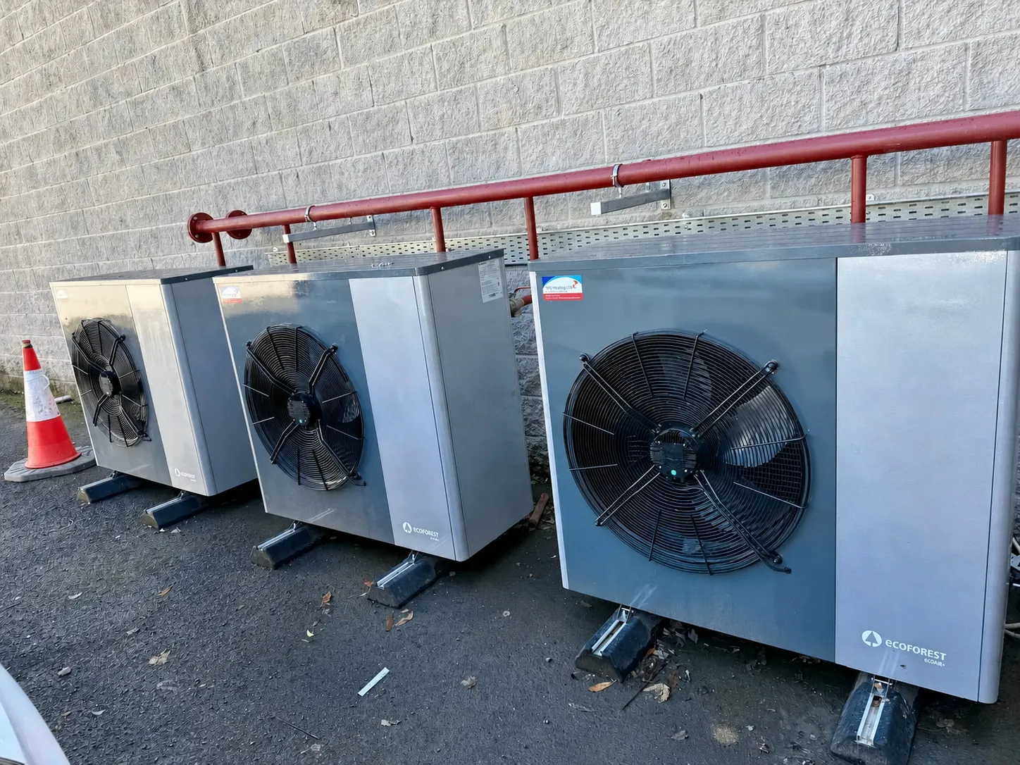 Bank of Ecoforest commercial heat pumps outside a business premises