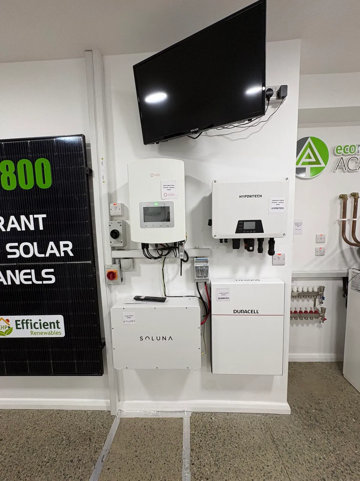 Solar PV panel, inverters and home batteries mounted on the EHP showroom display wall