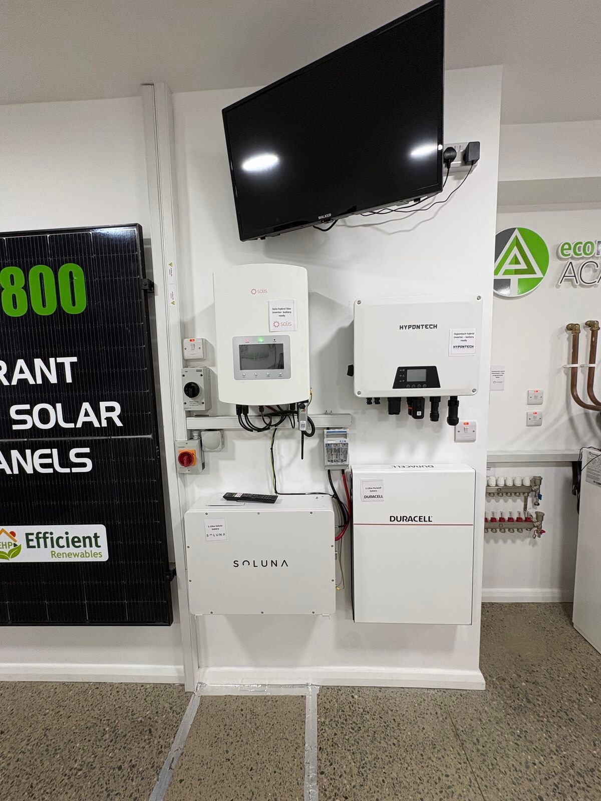 Solar PV panel, inverters and home batteries mounted on the EHP showroom display wall