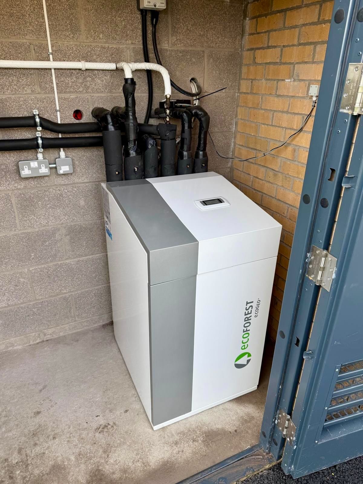 Ecoforest heat pump installed in a utility room